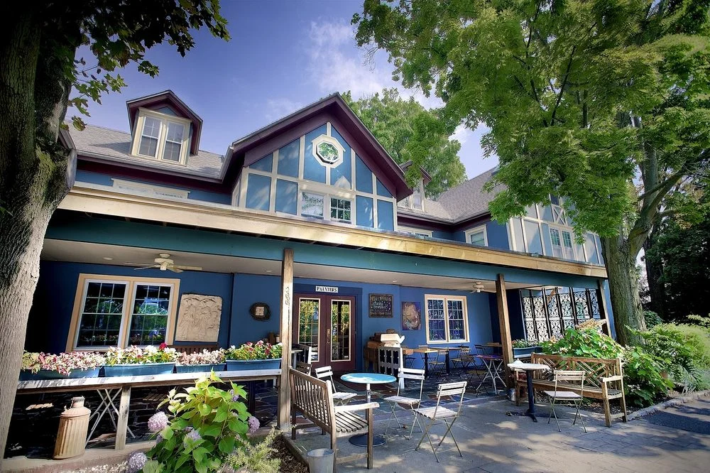 A vibrant restaurant interior with colorful paintings and cozy seating.