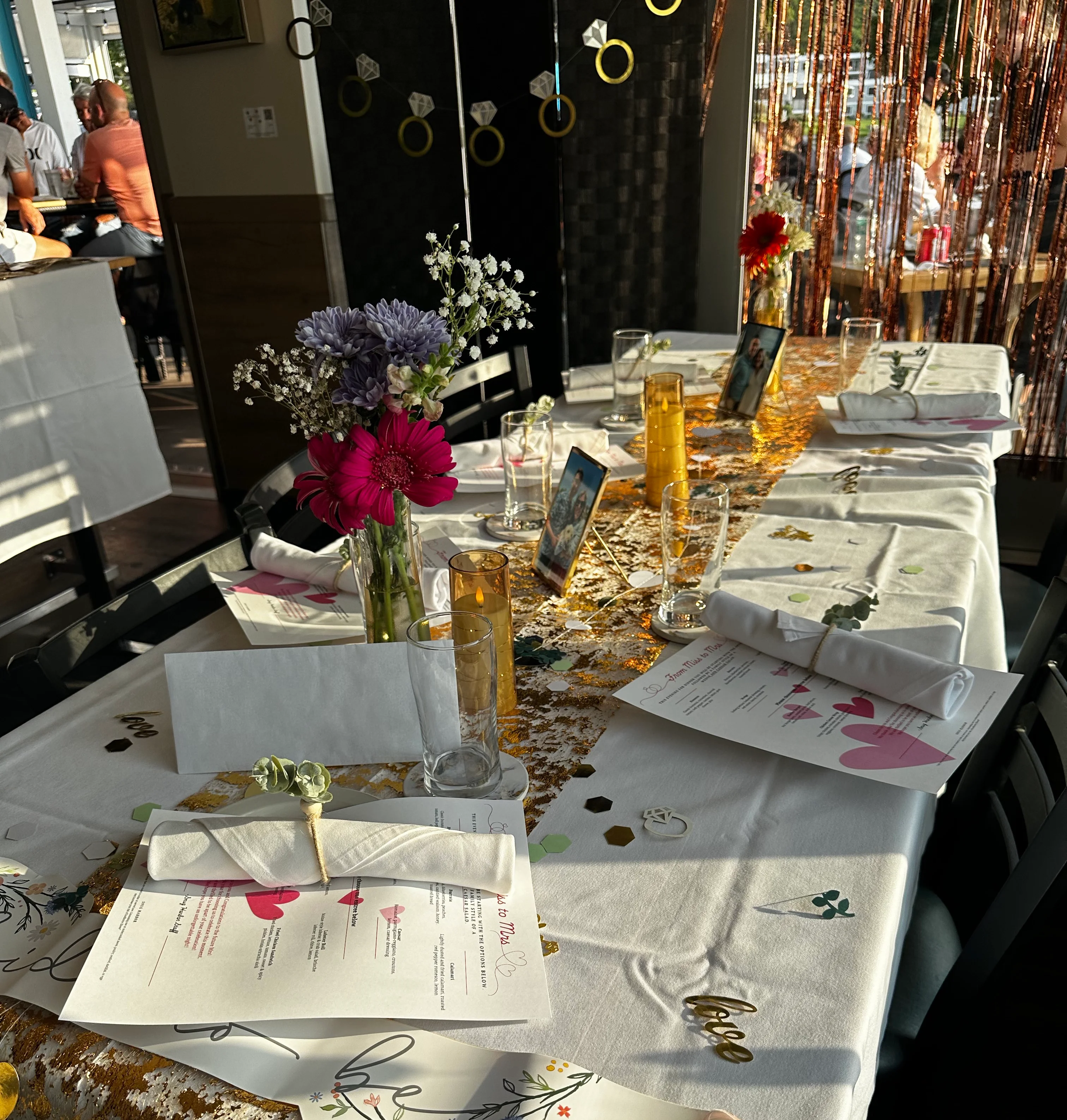 Lively restaurant scene with patrons enjoying drinks and conversation