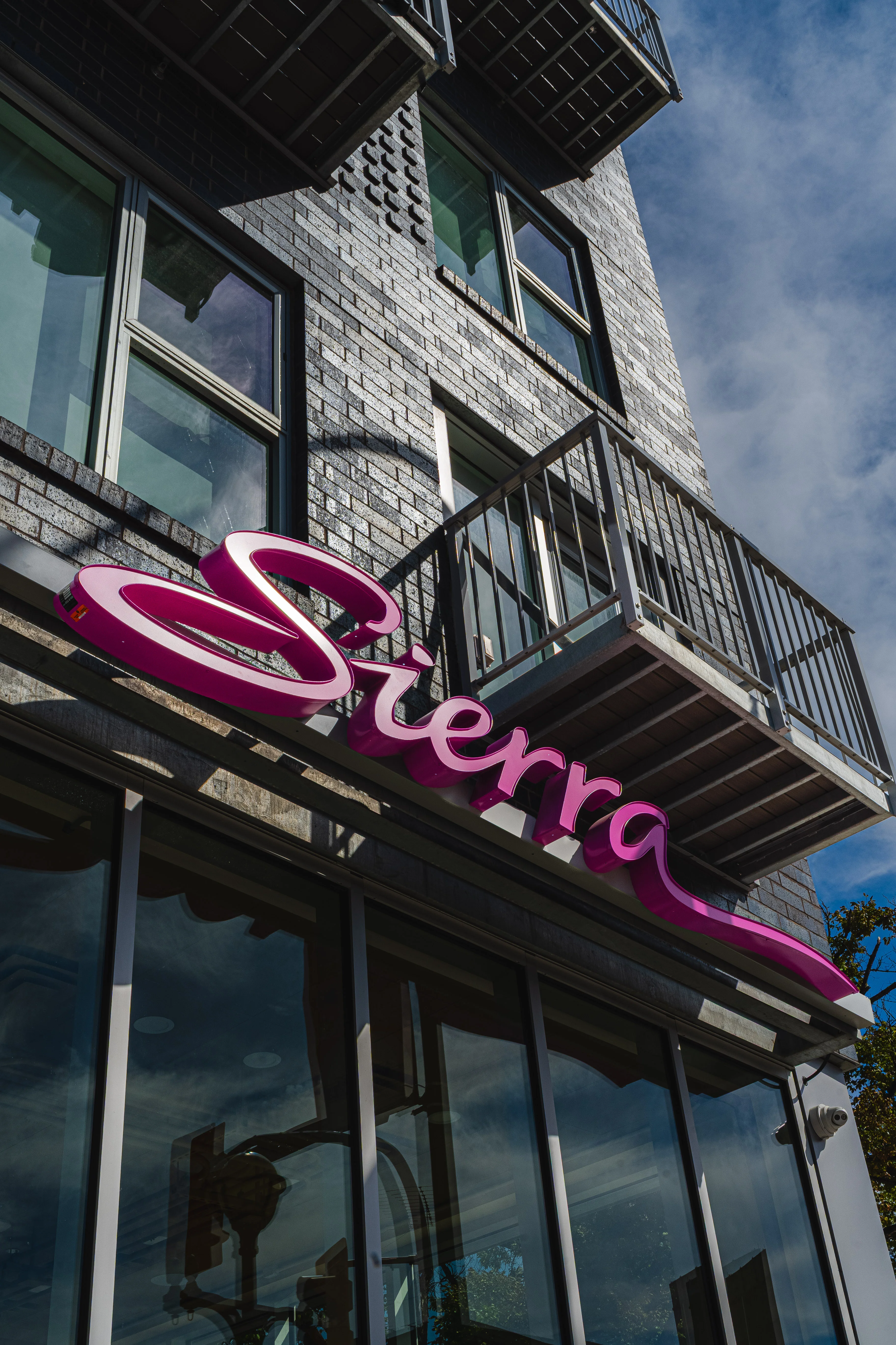 Exterior view of Sierra restaurant with modern signage and large windows