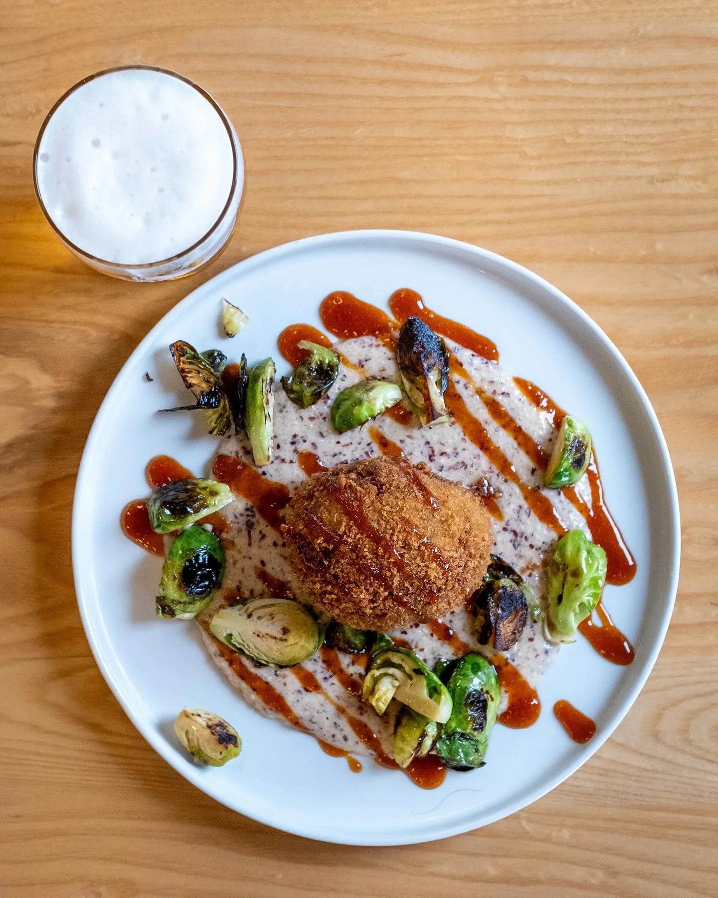 Crispy fried risotto ball with Brussels sprouts and sauce