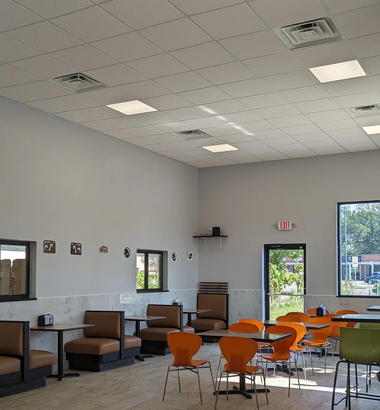 Modern restaurant interior with colorful seating and natural light