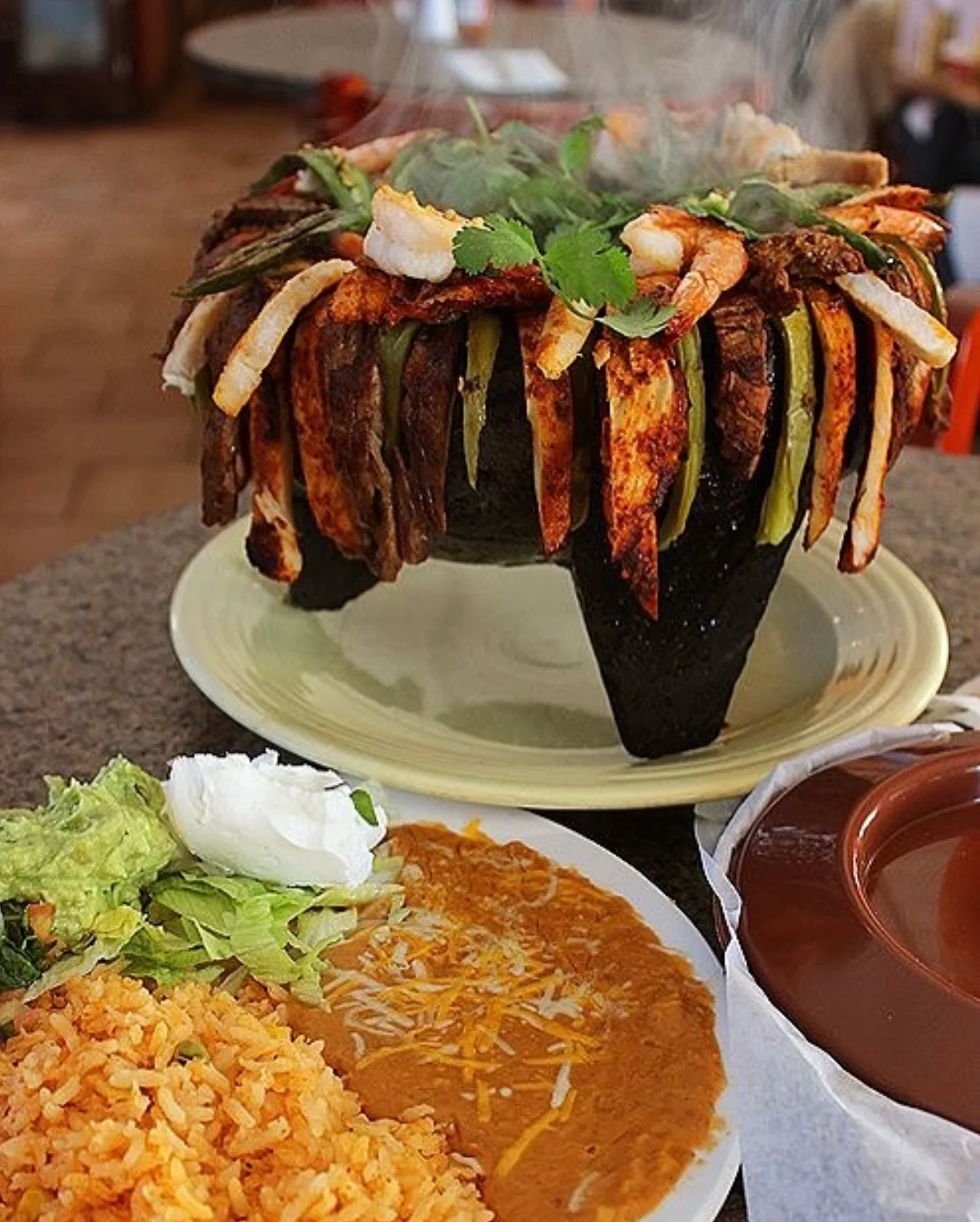Sizzling Mexican fajitas served in a molcajete