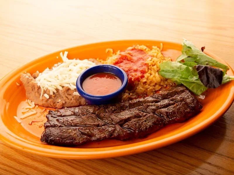 Grilled carne asada plate with rice and beans