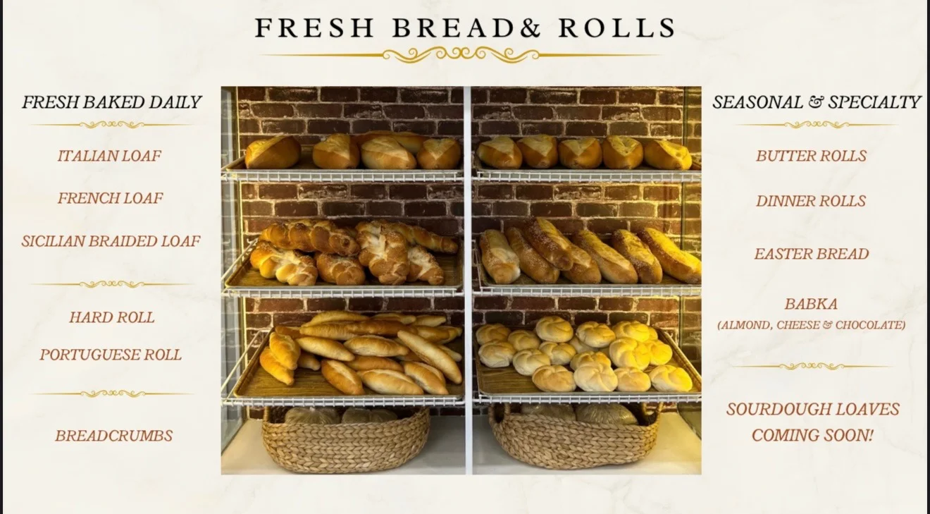 Freshly baked artisan bread and rolls display in a rustic bakery