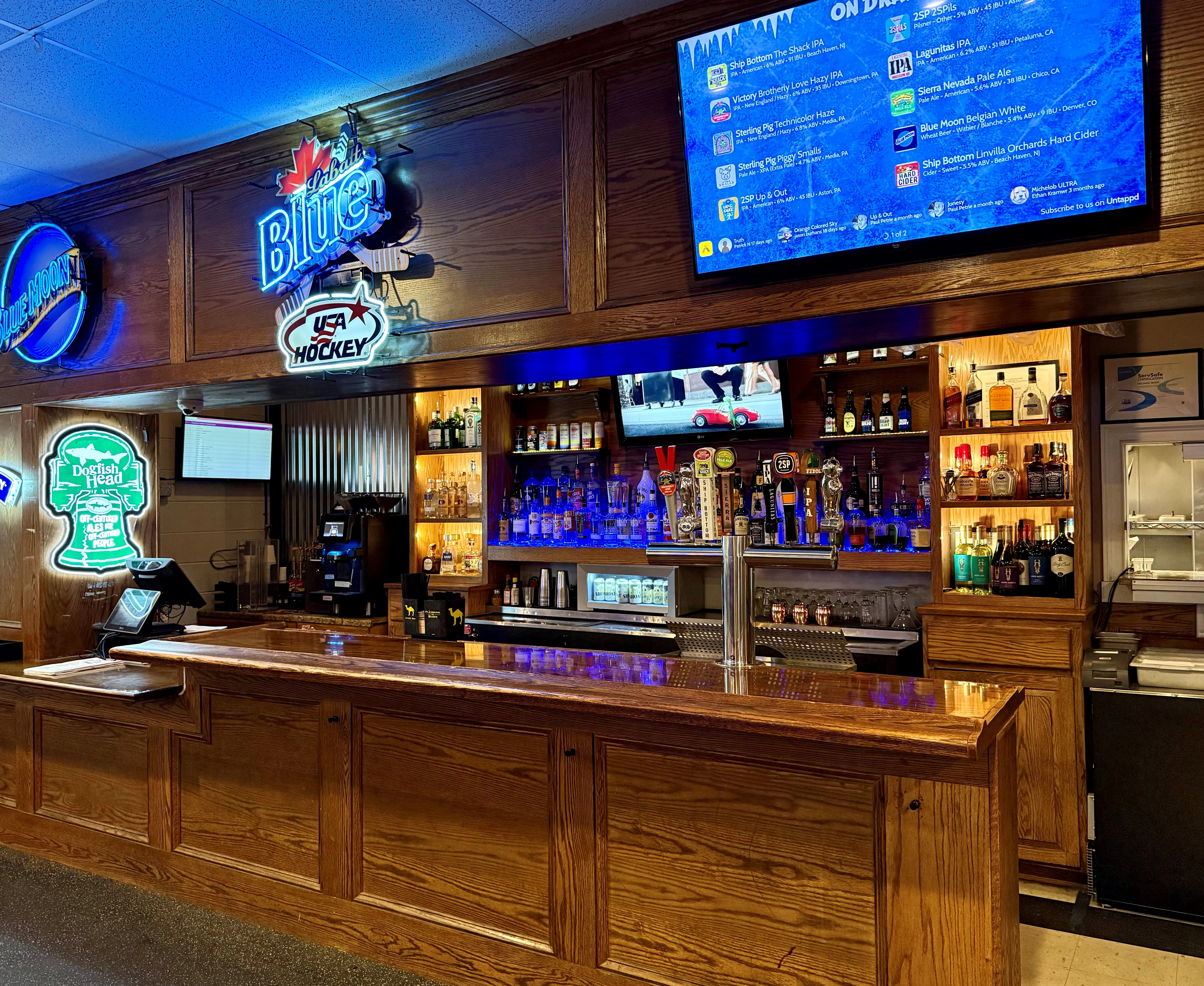 Modern bar counter with neon signs and draft beer selection