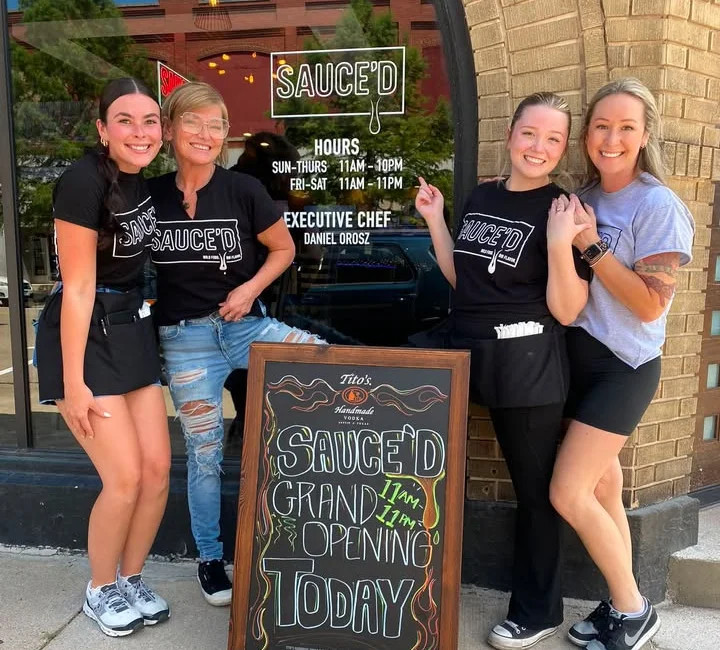 Staff celebrating the grand opening of Sauce'd restaurant