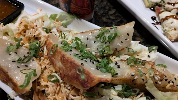 Crispy Japanese gyoza served on a bed of cabbage and noodles
