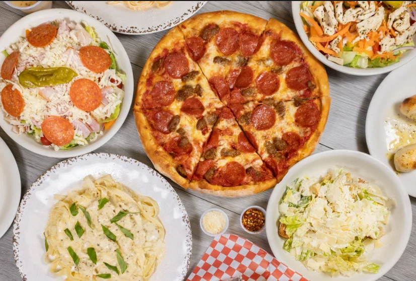 Variety of pizzas and appetizers in a vibrant restaurant setting