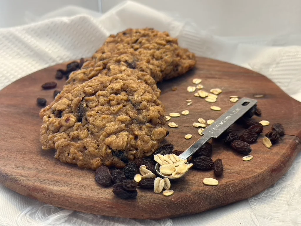 Oatmeal raisin cookies on a wooden platter