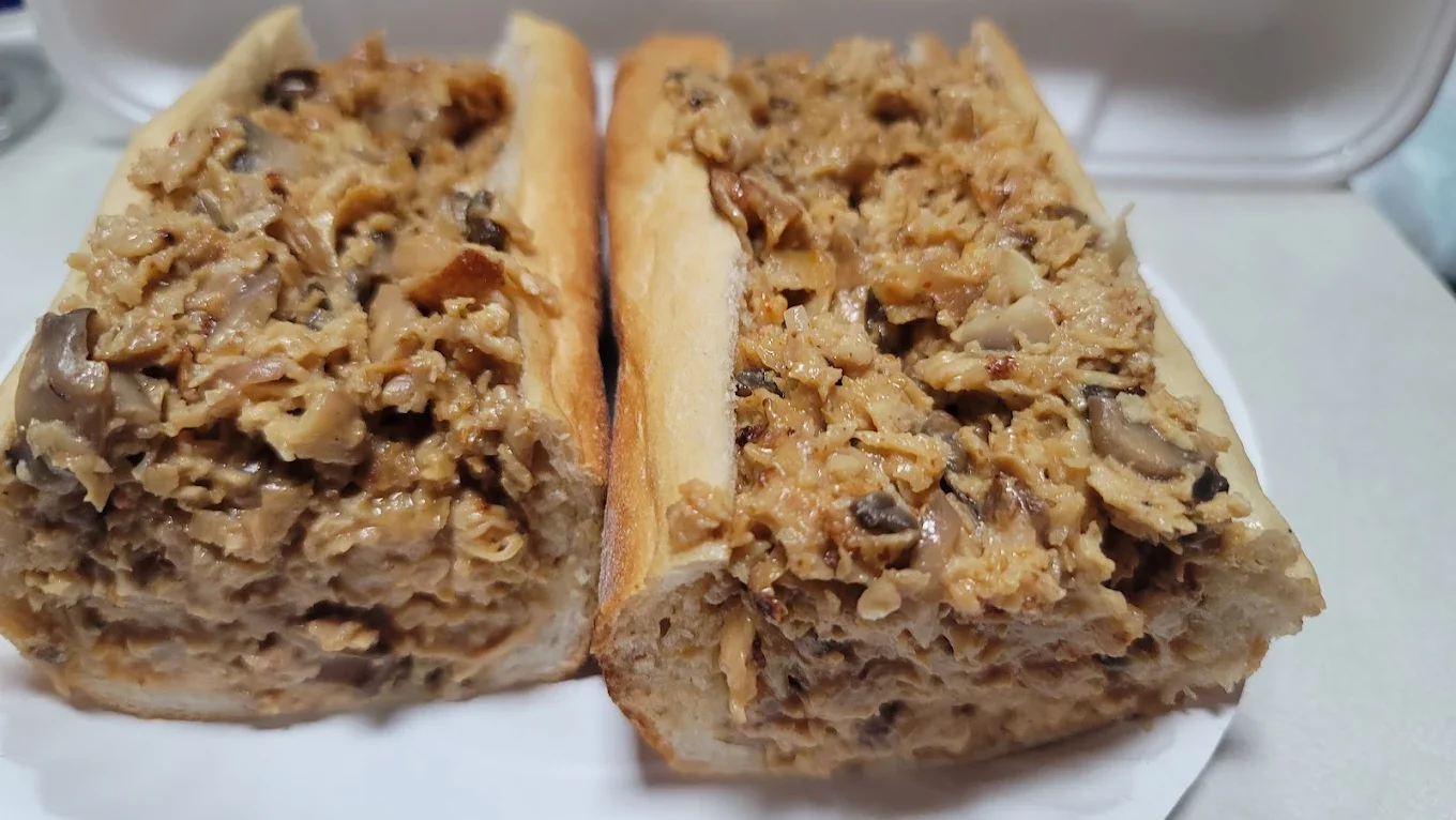 Delicious chicken cheesesteak sandwich cut in half