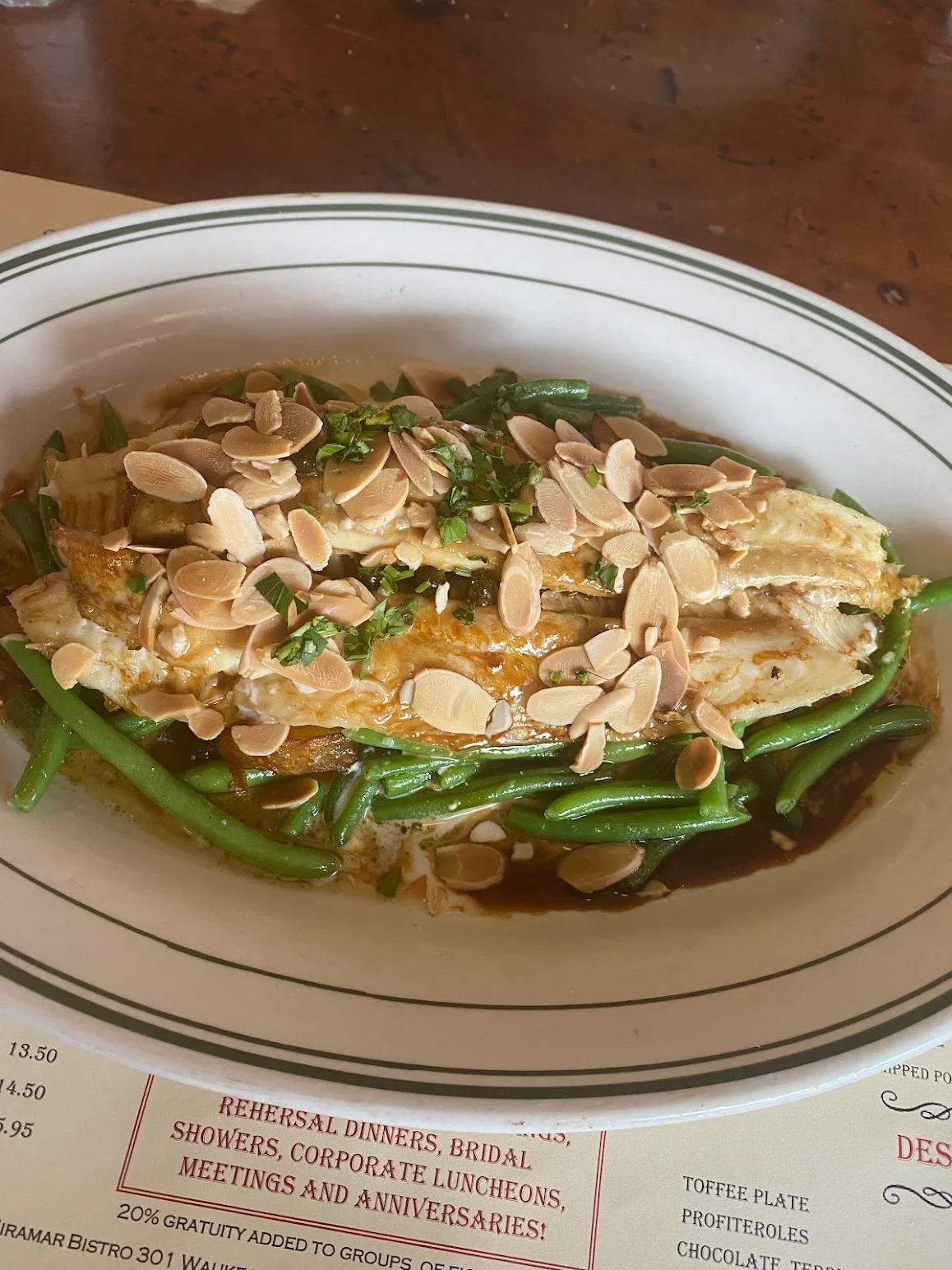 Almond-crusted fish with green beans in a savory sauce