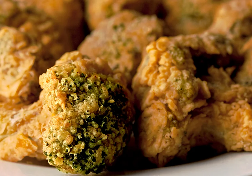 Crispy broccoli fritters on a white plate