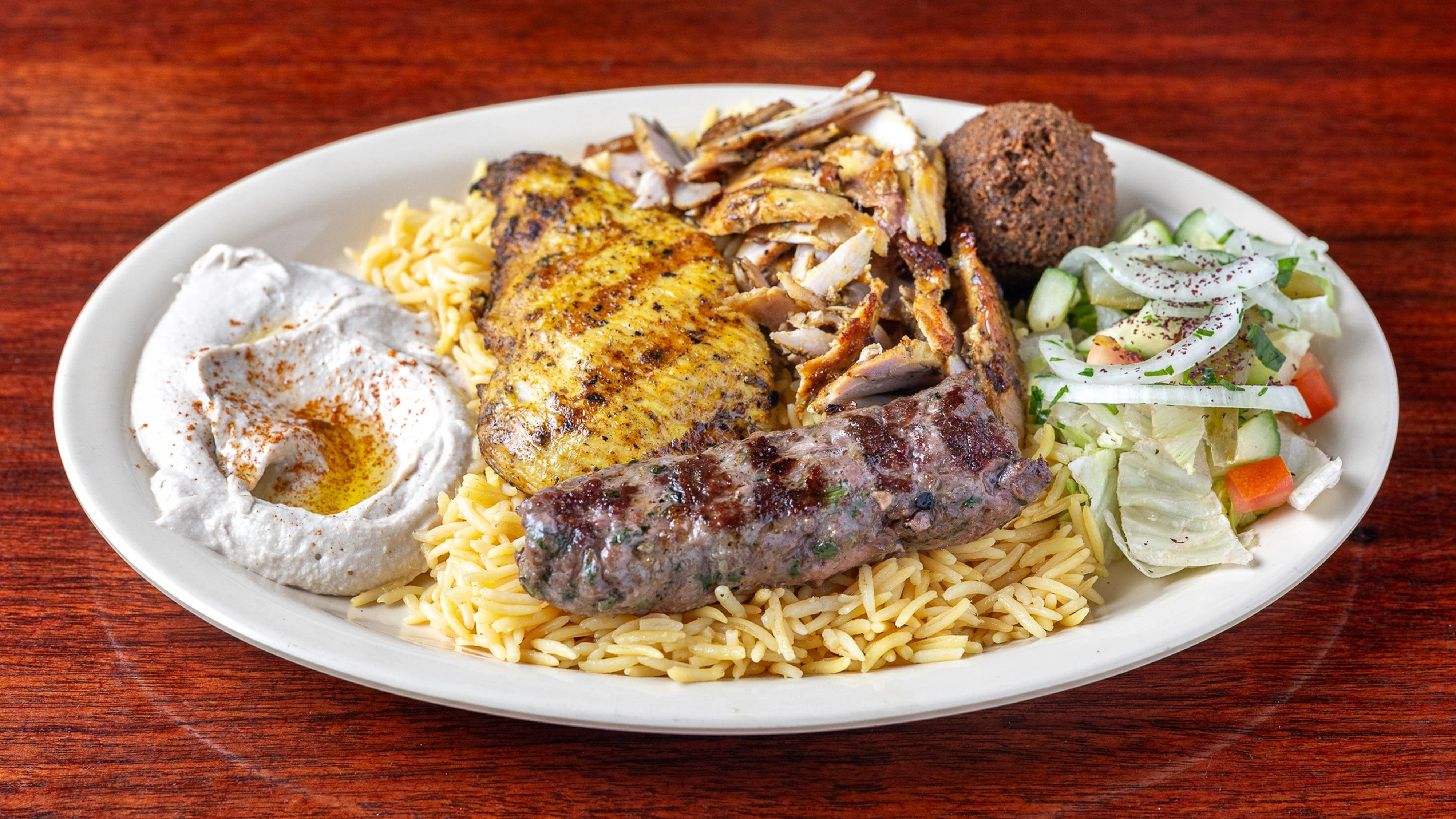 Pita Zone lunch plate with shawarma, grilled kababs and basmati rice