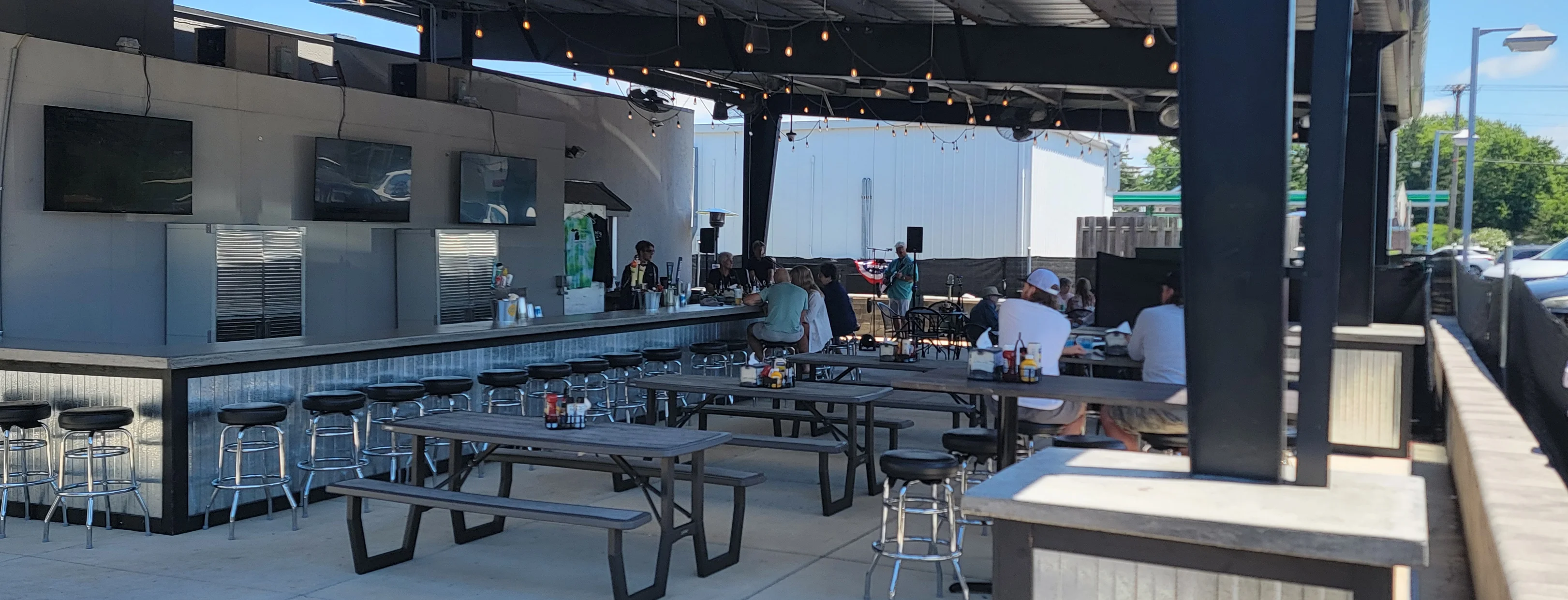 Outdoor bar area with seating and string lights