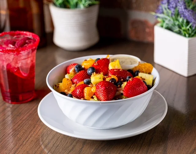Colorful fruit salad in a white bowl