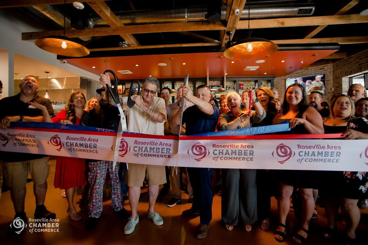 Ribbon cutting ceremony at a restaurant opening event