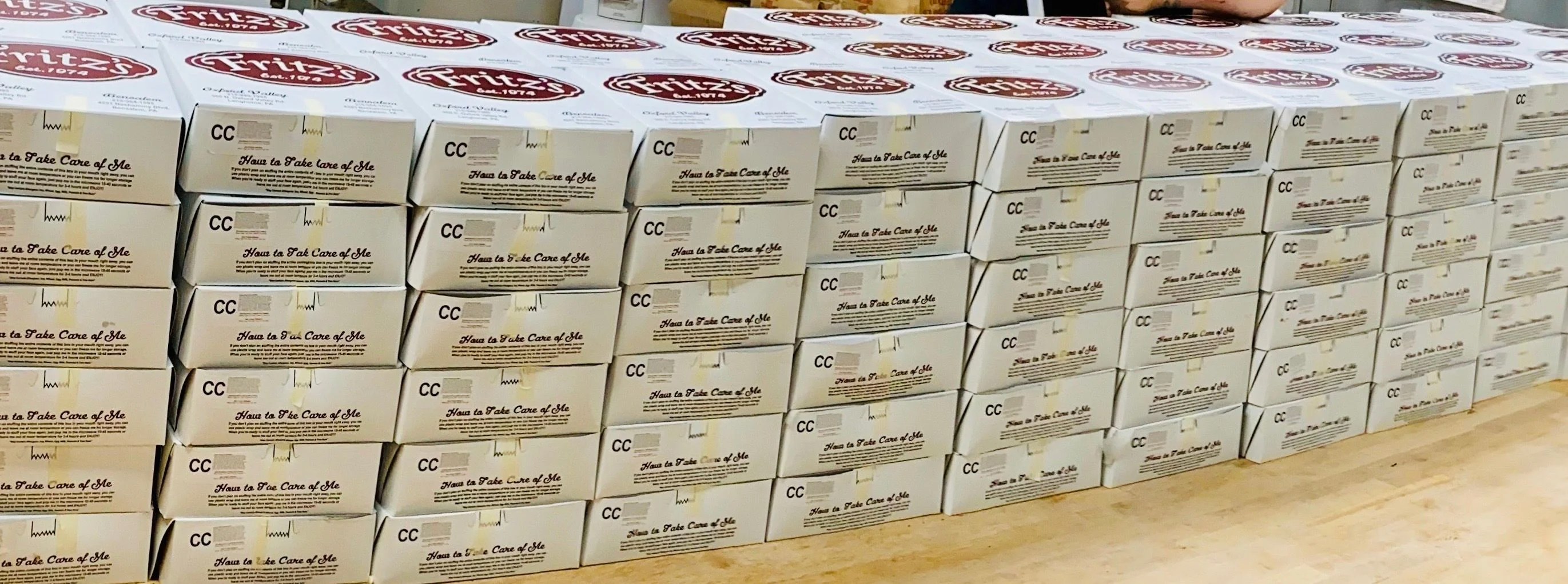 Stacked boxes of Fritz's restaurant takeout packaging