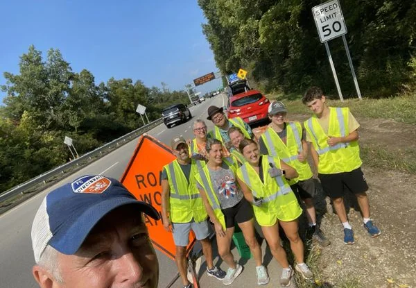 Group of volunteers in safety vests at a roadwork site