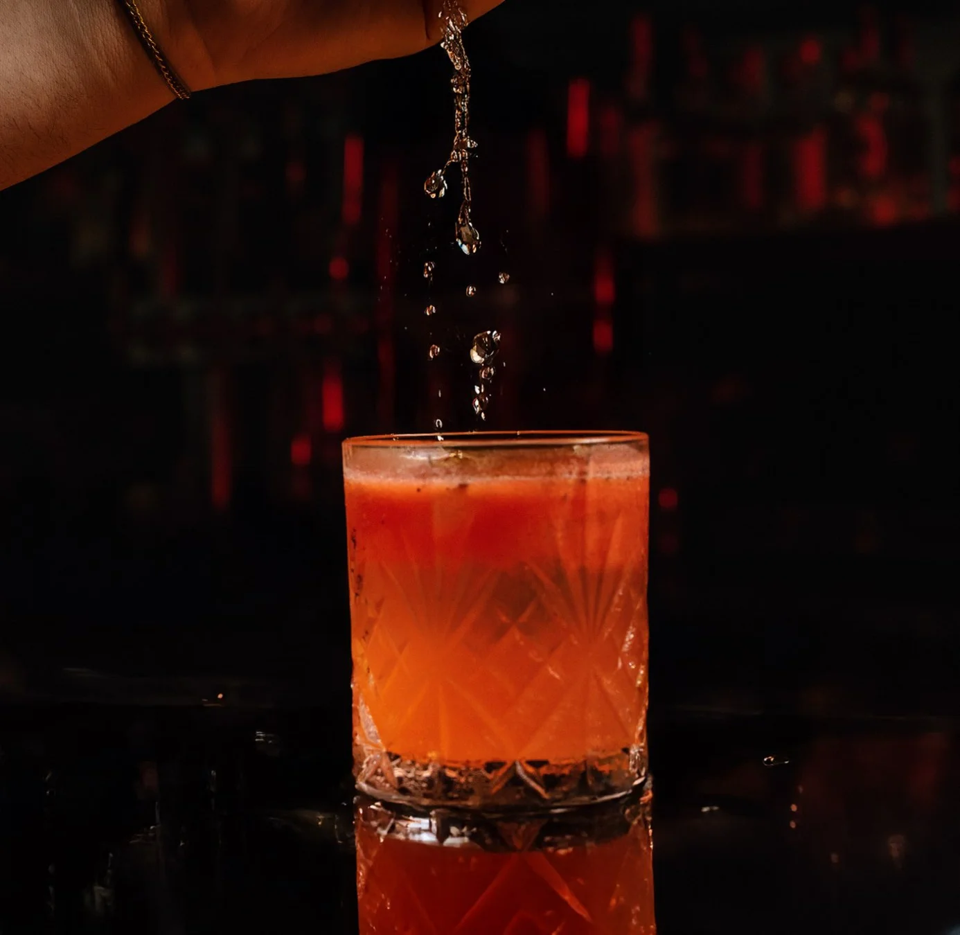 Cocktail with Hennessy and rum on a wooden bar counter