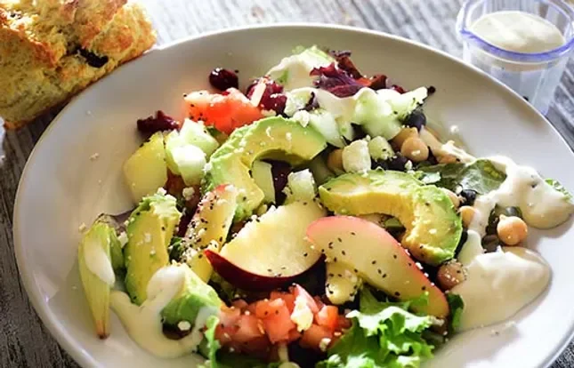 Fresh garden salad with avocado and creamy dressing