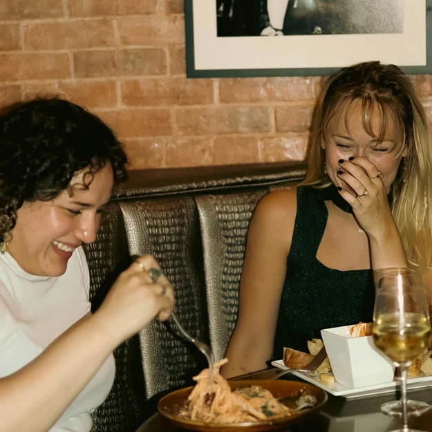 Two friends enjoying dinner in Fleetwood's Vault