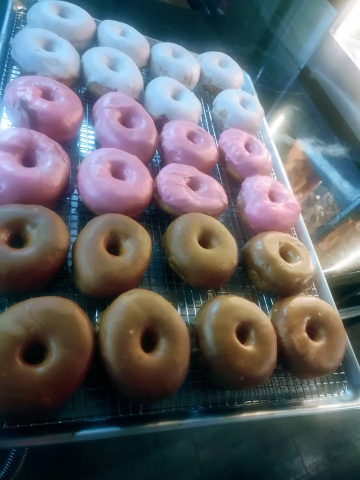 Assorted donuts including glazed and frosted varieties