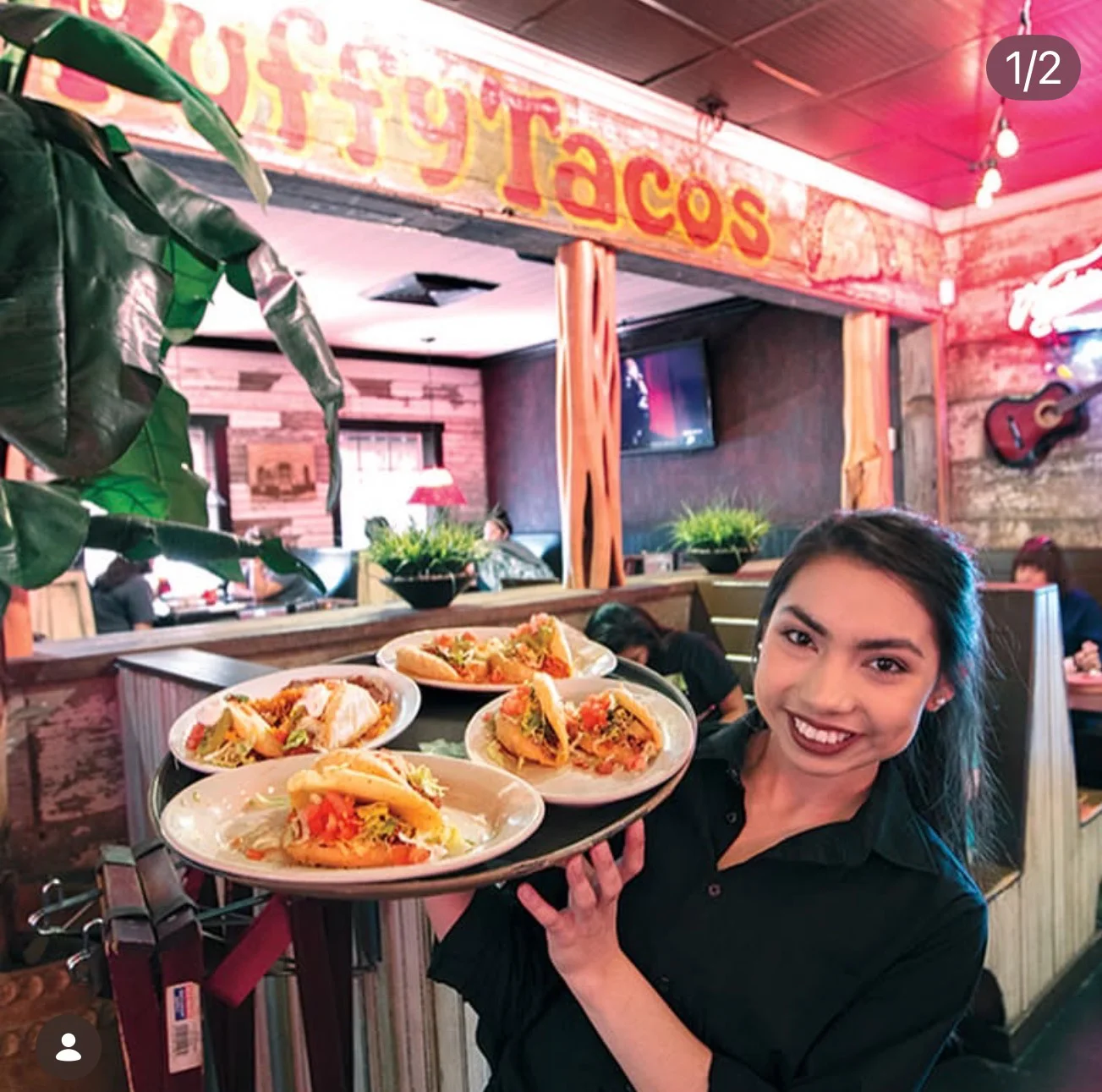 Delicious street tacos served on a tray in a vibrant restaurant setting