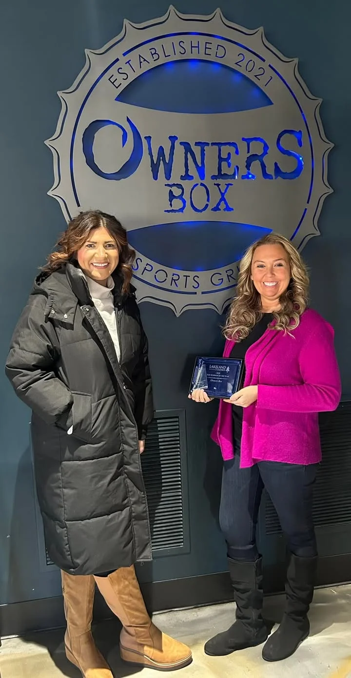 Two women celebrating an award at Owners Box restaurant