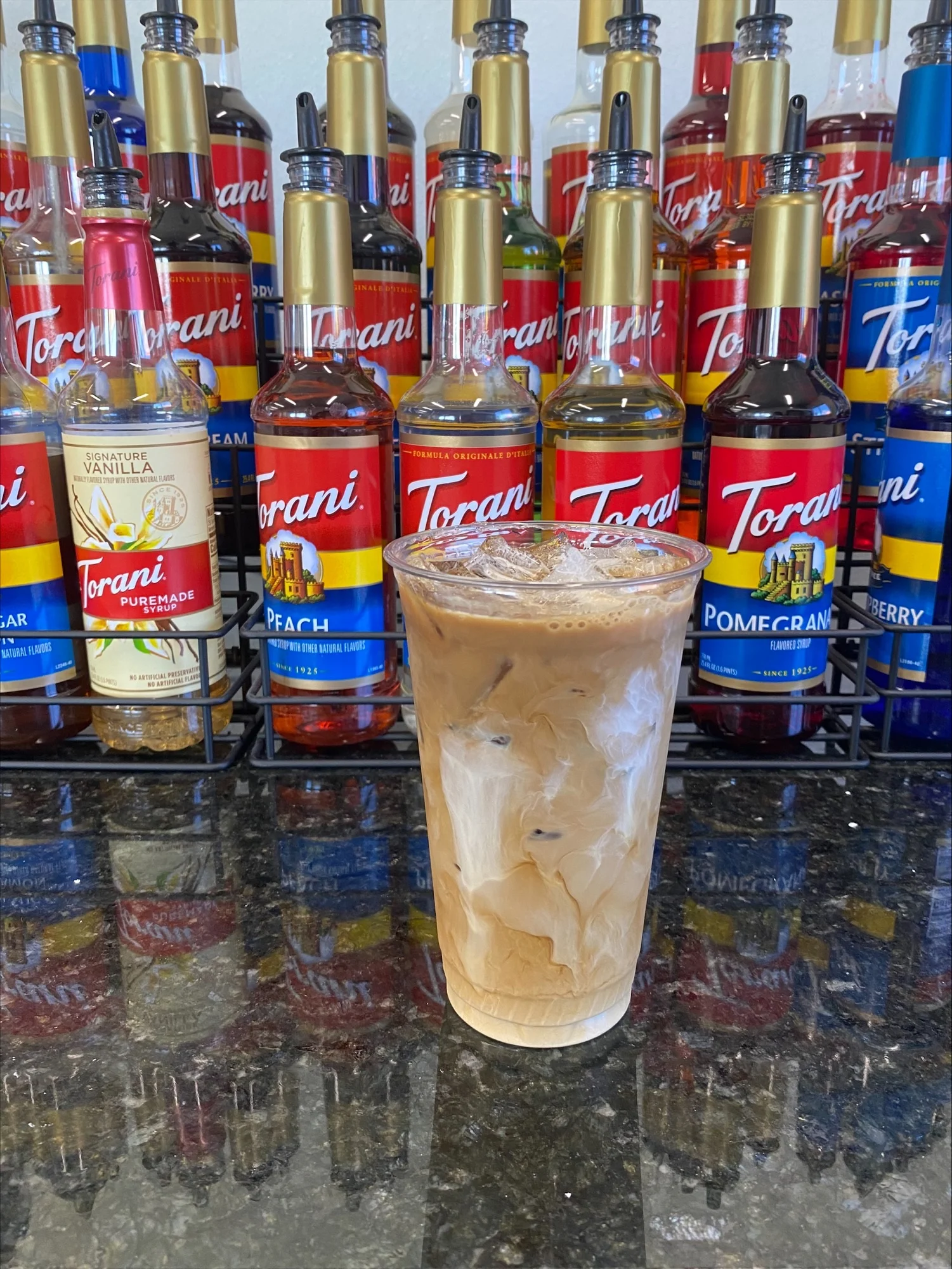 Iced coffee drink with creamy swirls and flavored syrups