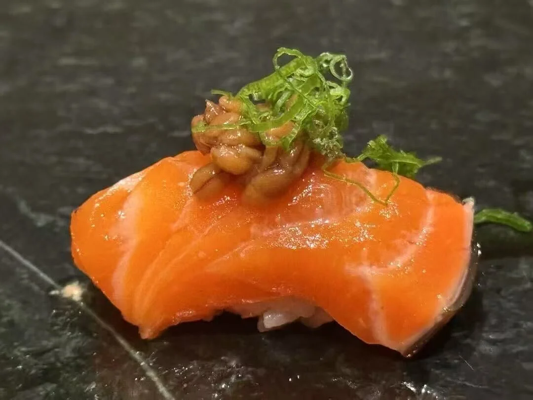 Japanese sushi nigiri with salmon and garnished toppings