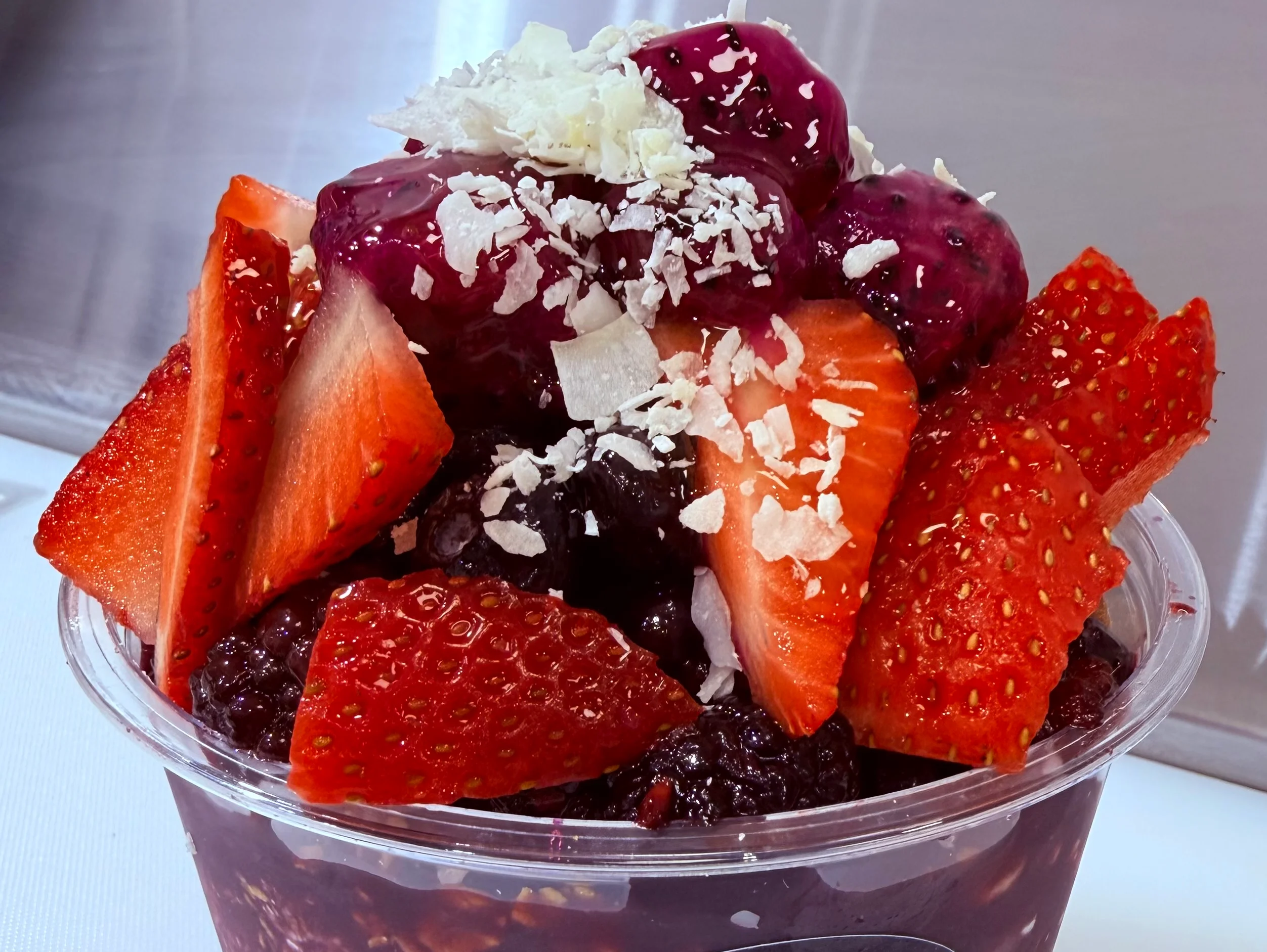 Acai bowl topped with fresh strawberries and berries