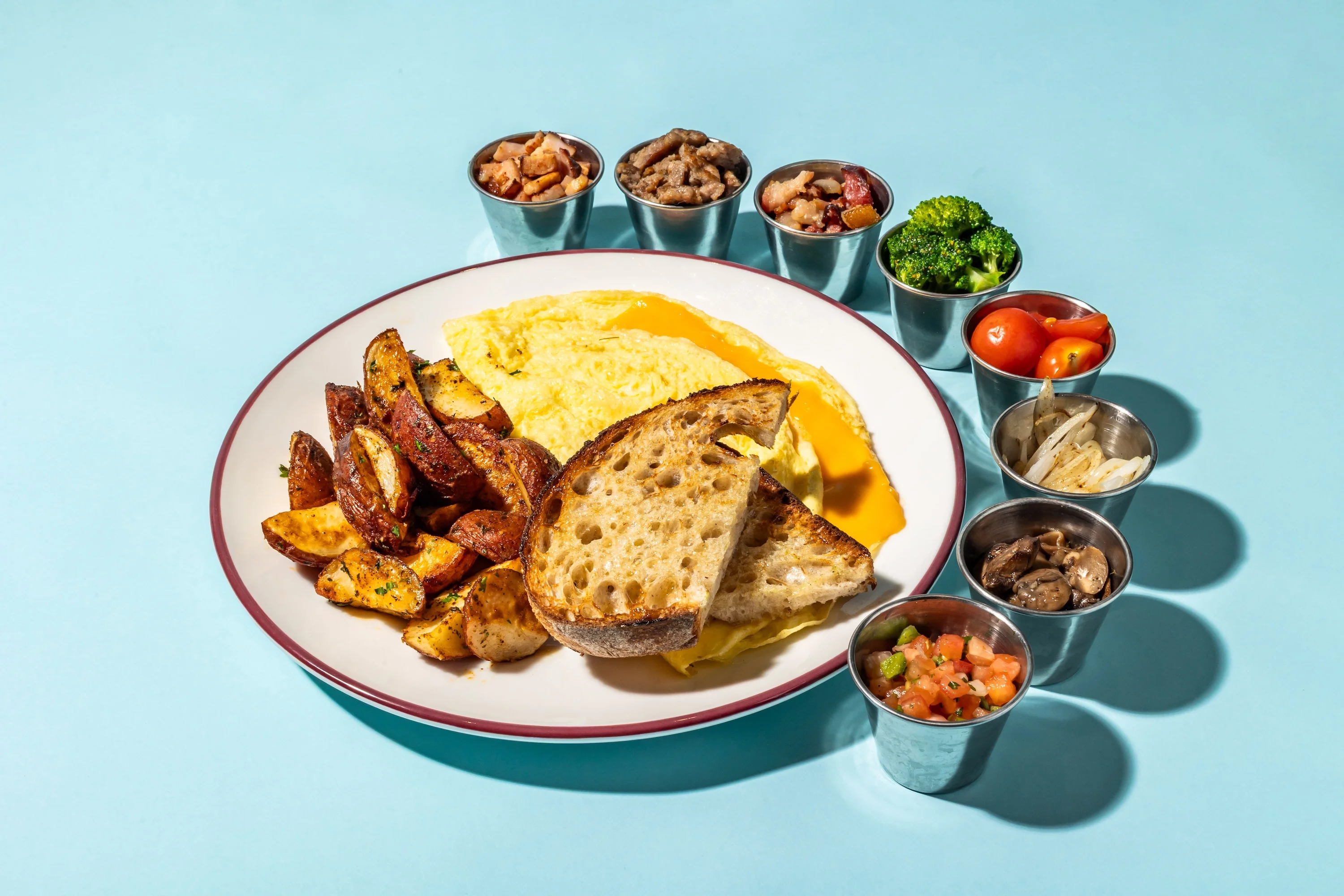 Classic American breakfast plate with omelette, potatoes, and assorted toppings