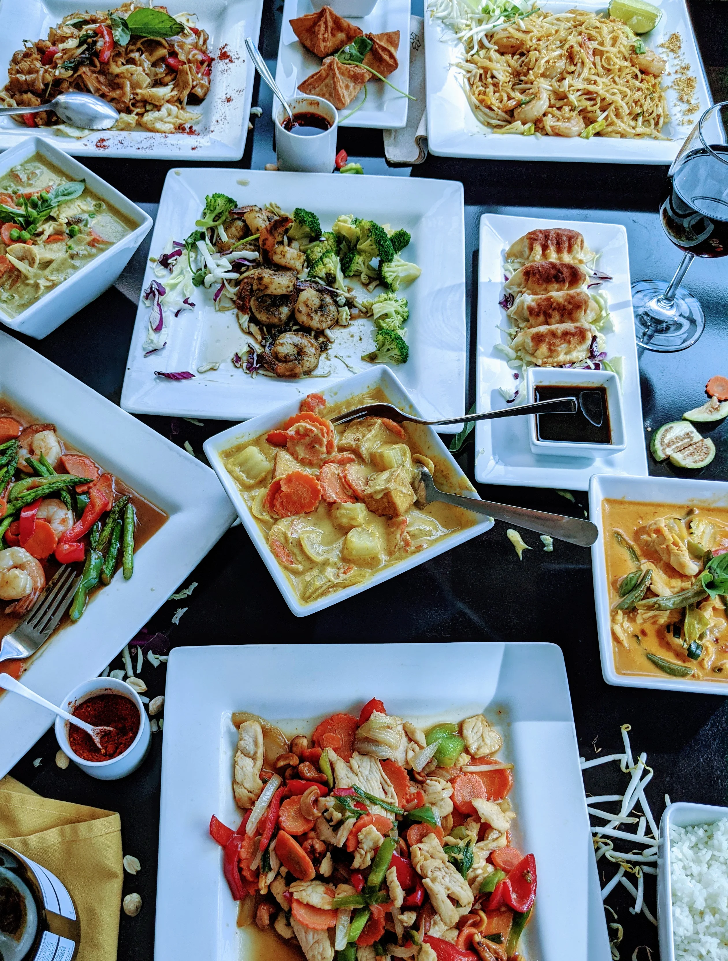 Assorted Thai dishes including pad thai and green curry