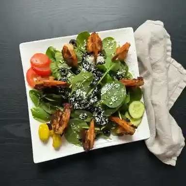 Mediterranean grilled chicken salad with greens and feta