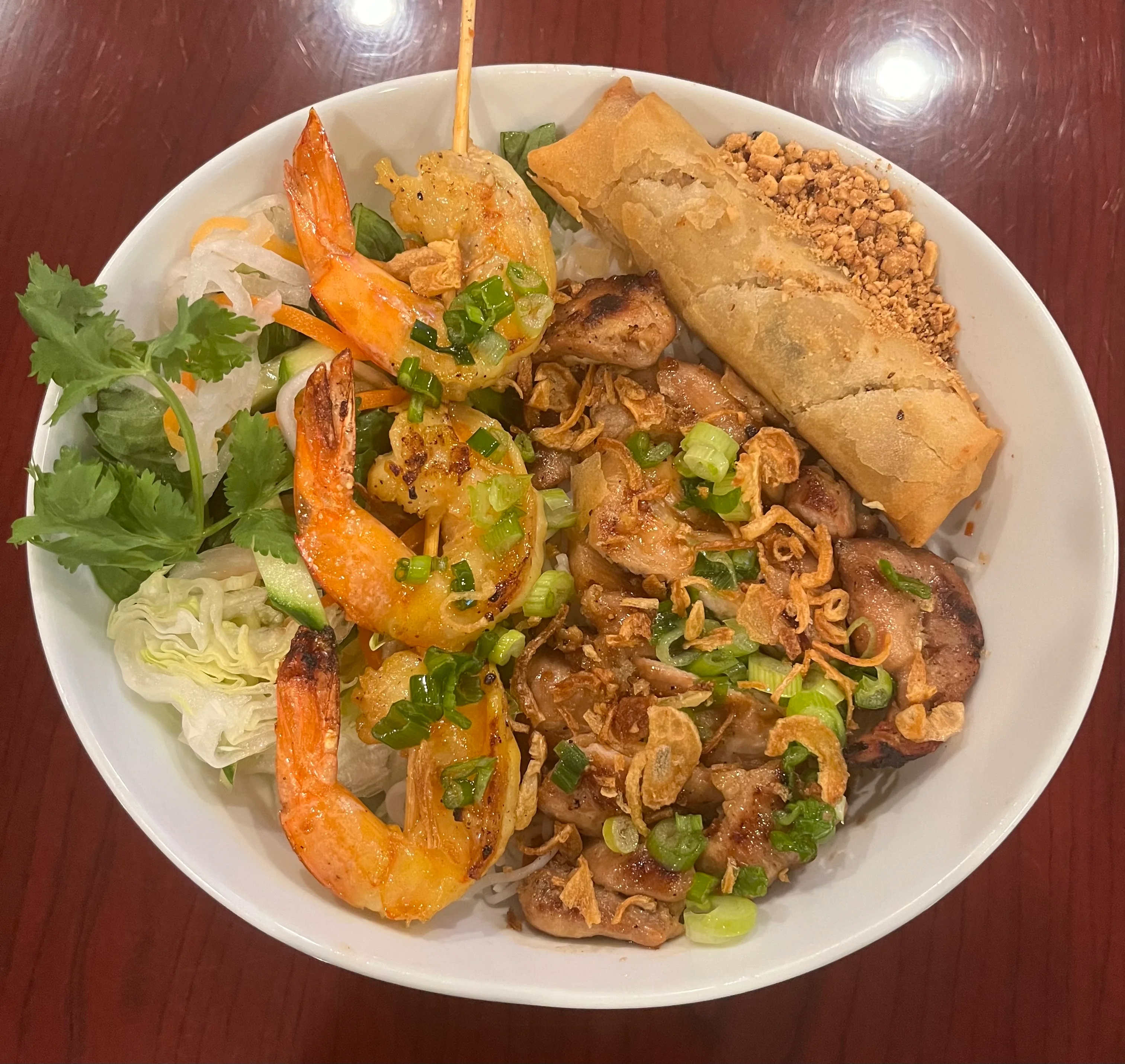Vietnamese bun thit nuong with grilled shrimp and spring rolls