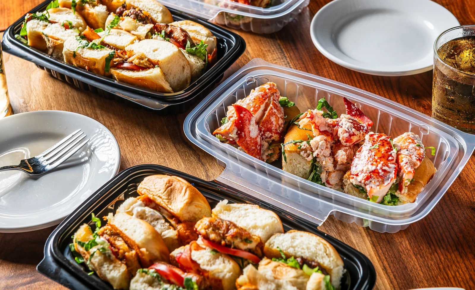 Lobster rolls and sliders in takeout containers