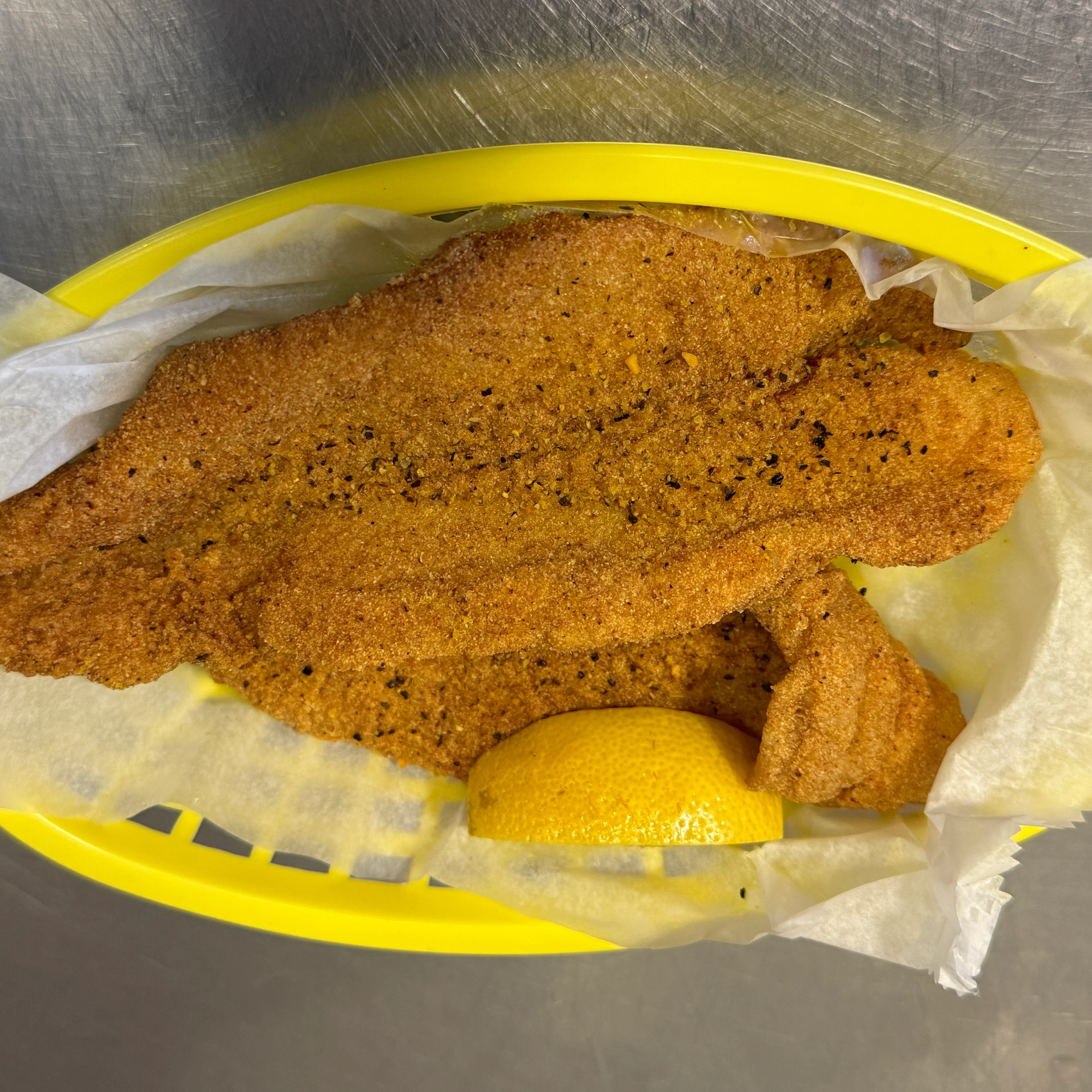 Southern fried catfish with lemon wedge