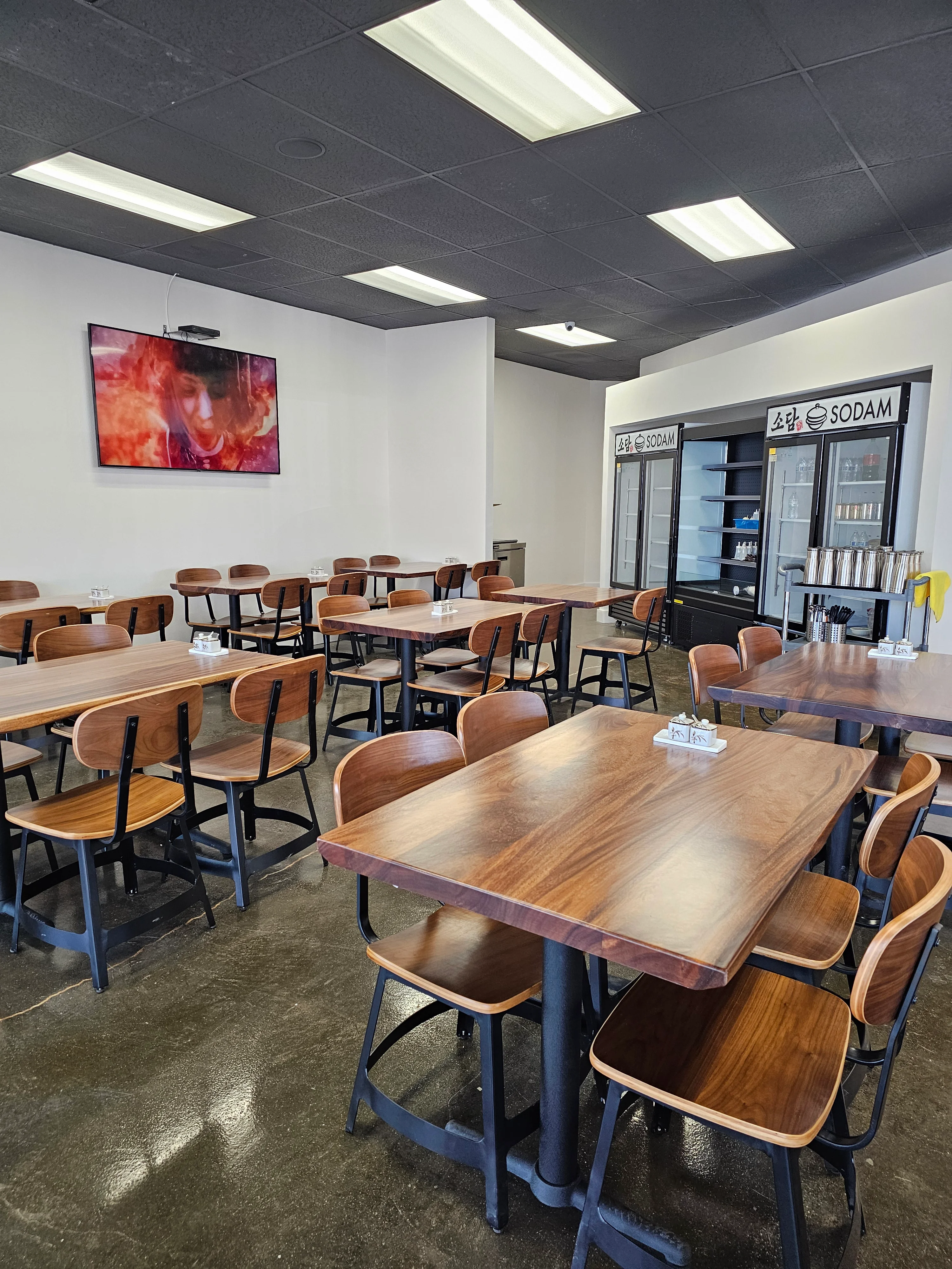 Modern restaurant interior with wooden tables and chairs