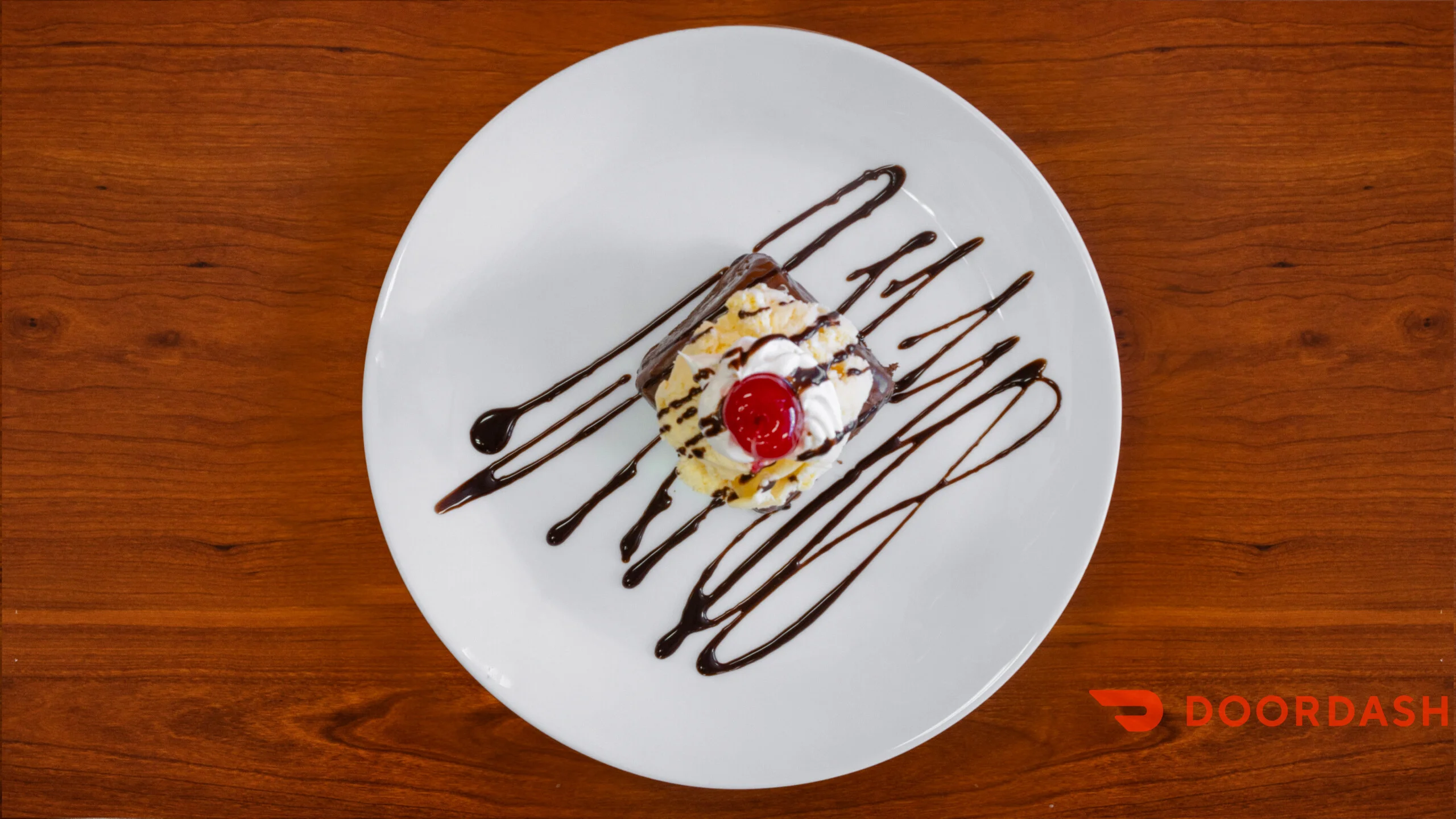 Decadent chocolate brownie sundae with whipped cream and cherry