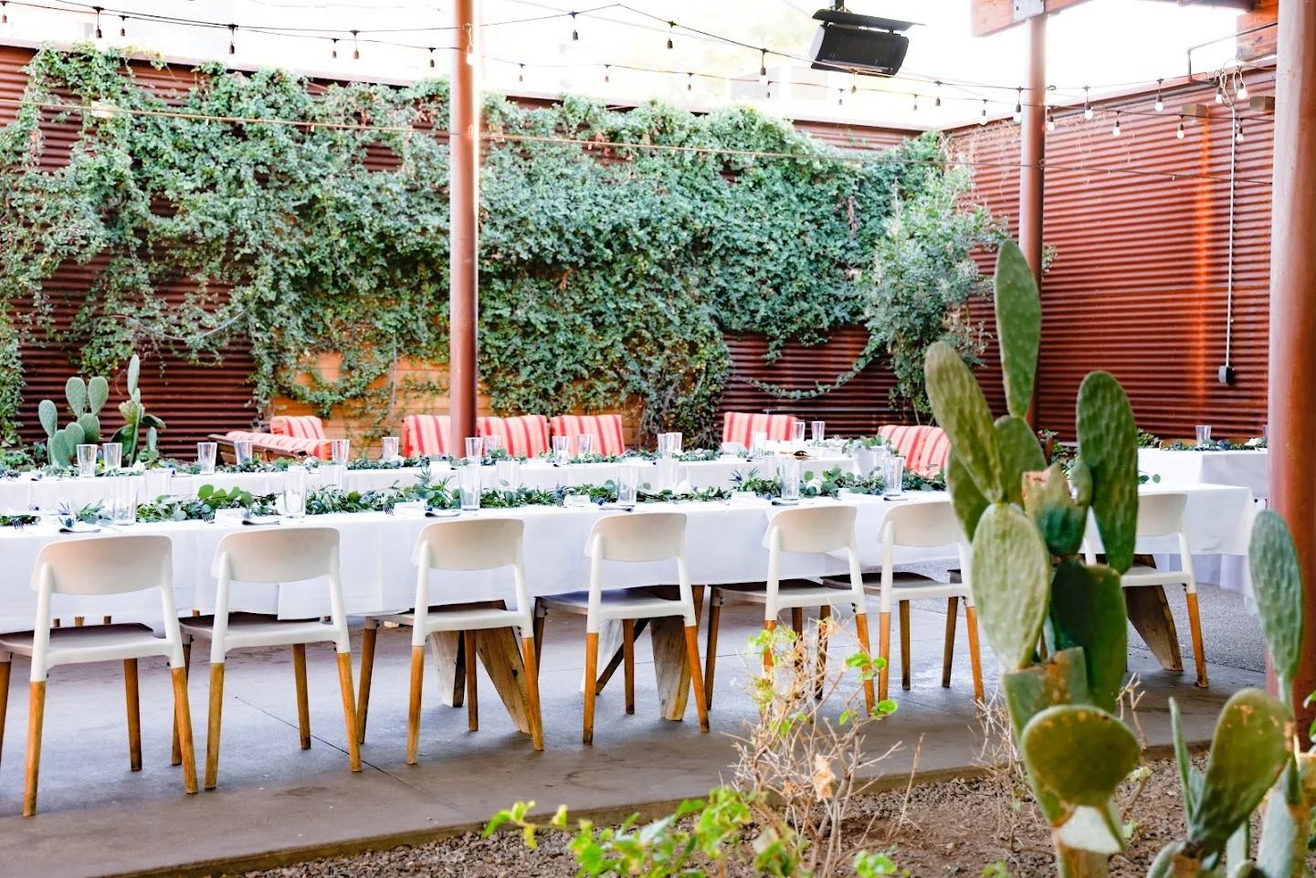 Outdoor dining setup with greenery and rustic decor