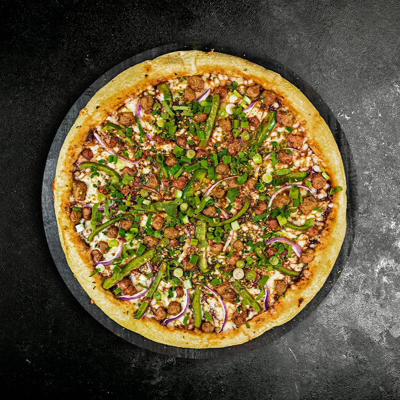 Delicious Indian-style pizza topped with spices and fresh herbs