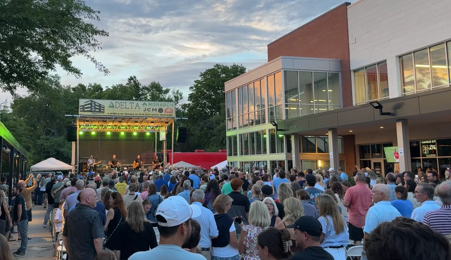 Outdoor concert crowd enjoying live music at sunset