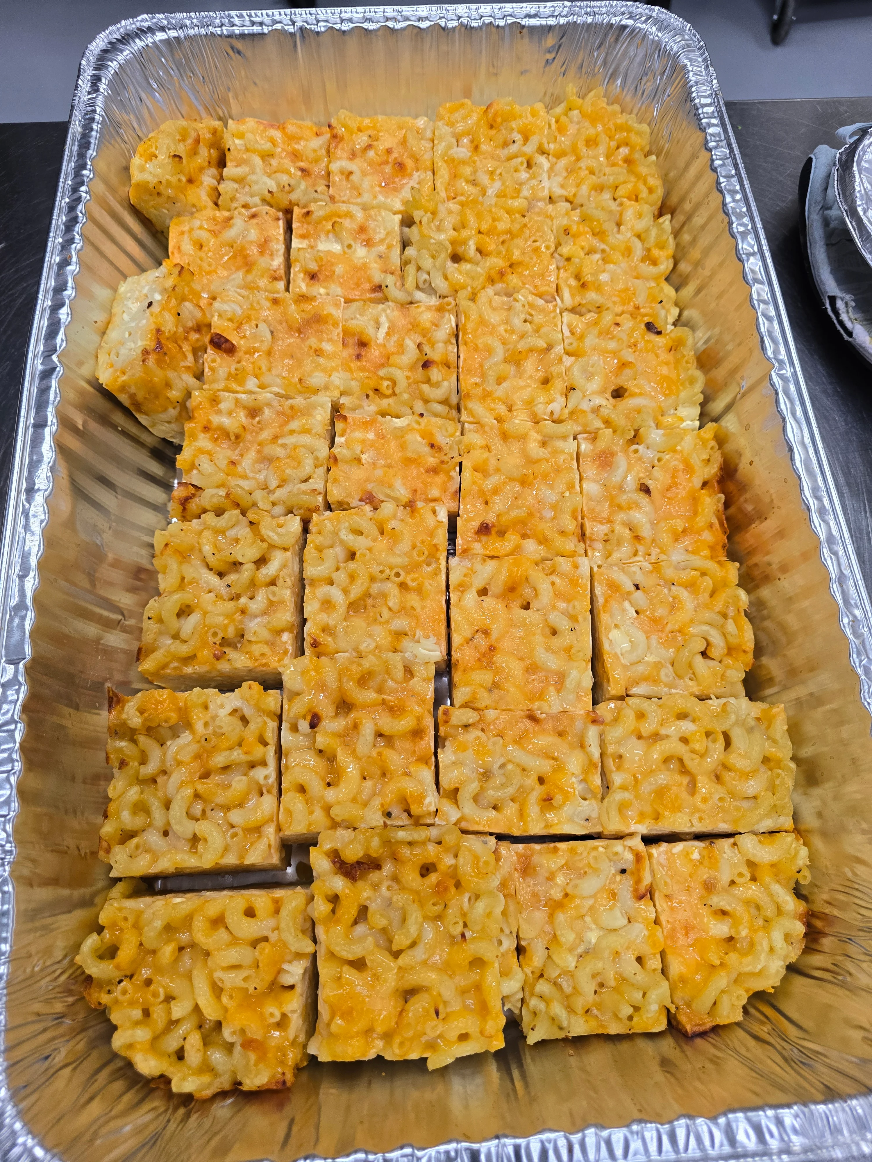 Baked macaroni and cheese squares in a tray