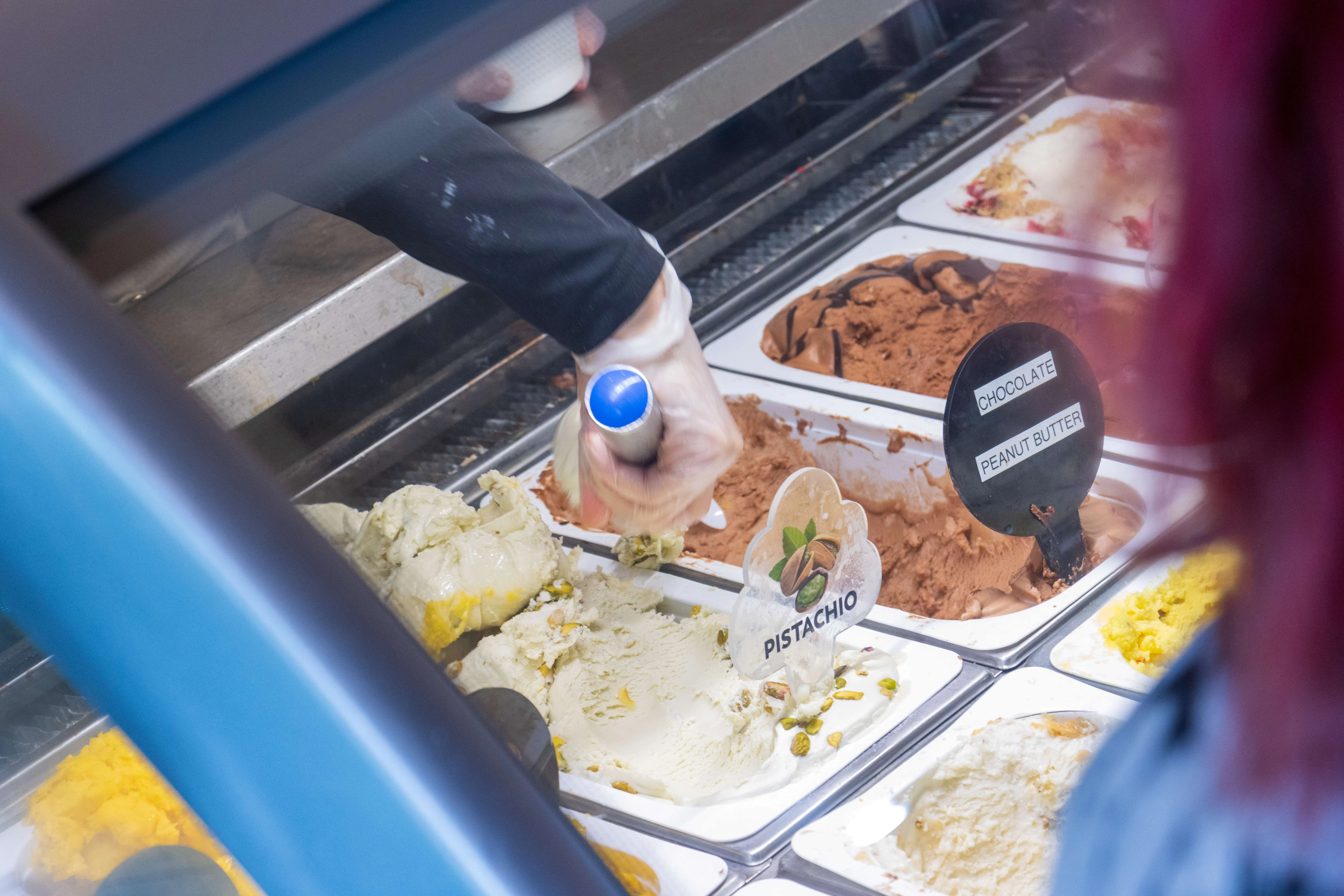 Scoop of pistachio gelato in a dessert shop