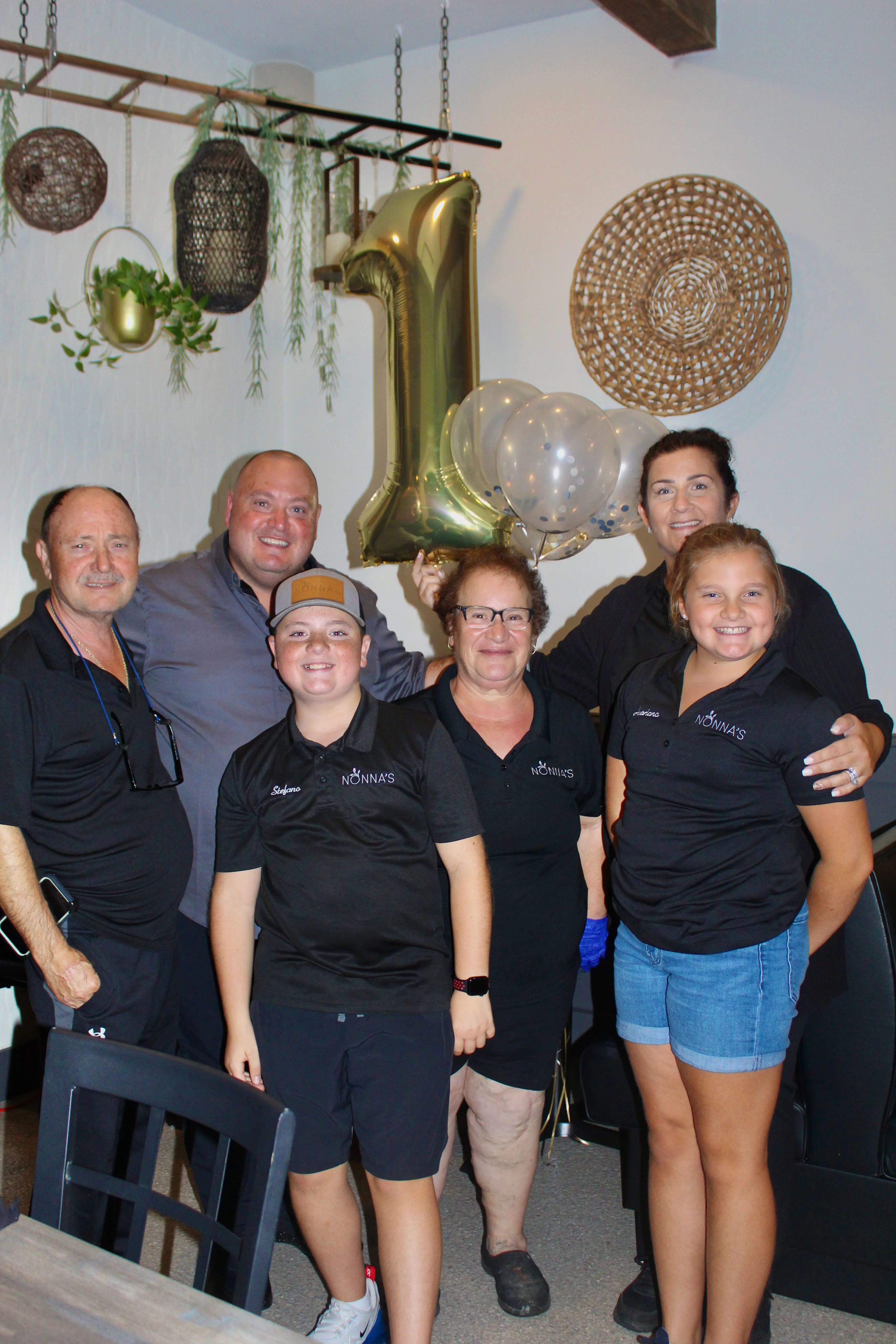 Celebrating a restaurant's first anniversary with staff and balloons