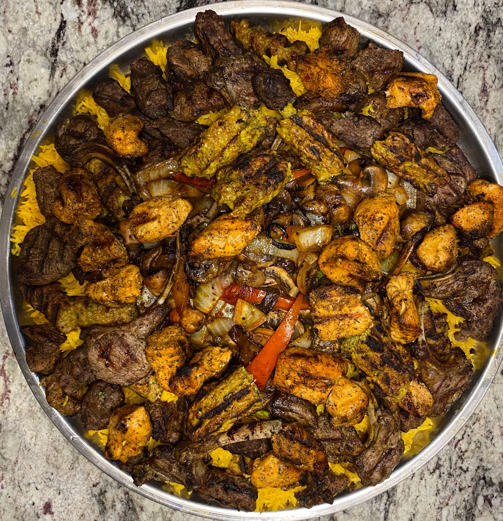 Mixed grill platter featuring kebabs and marinated meats