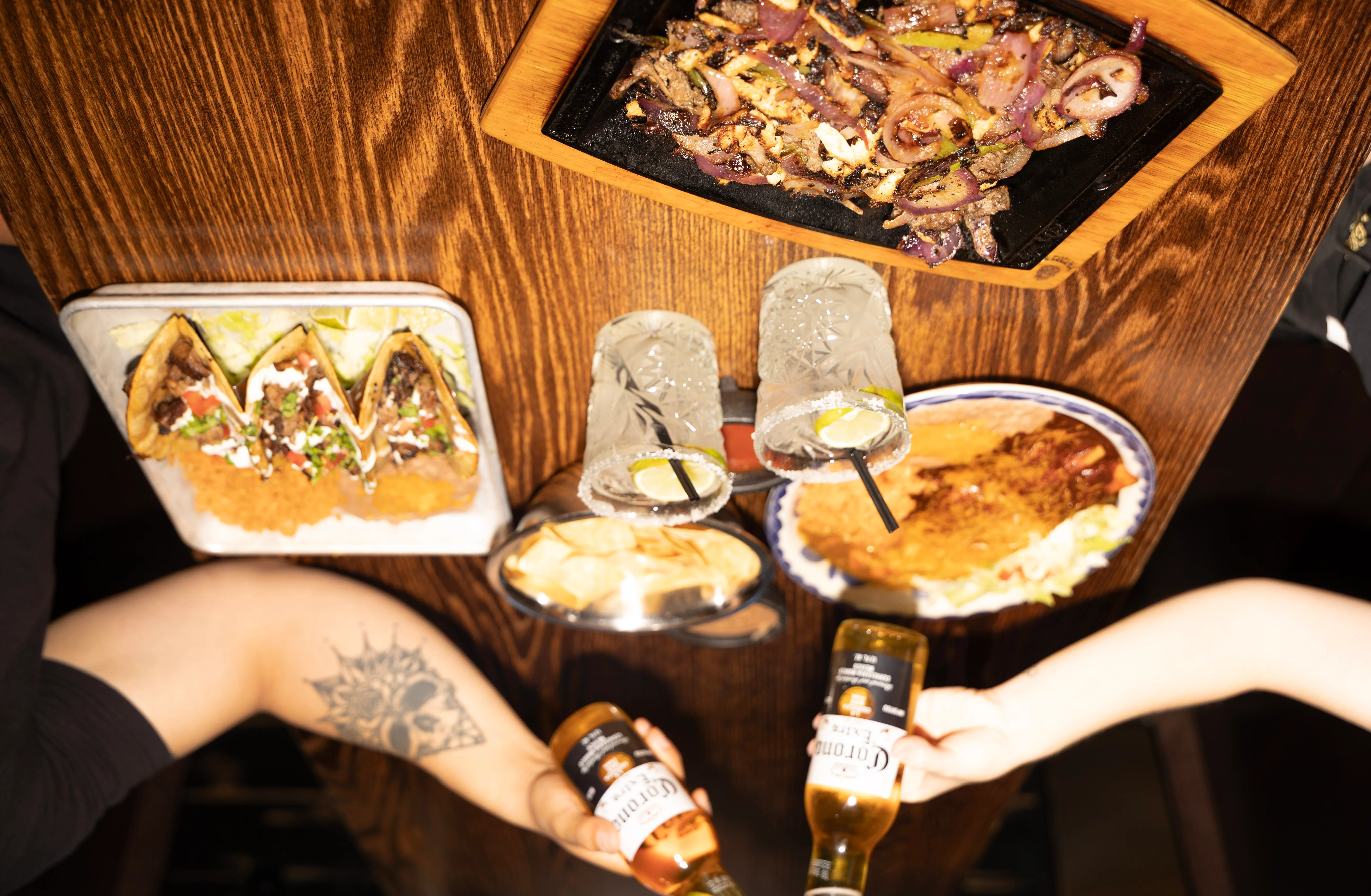 Colorful Mexican platter with tacos and sizzling fajitas