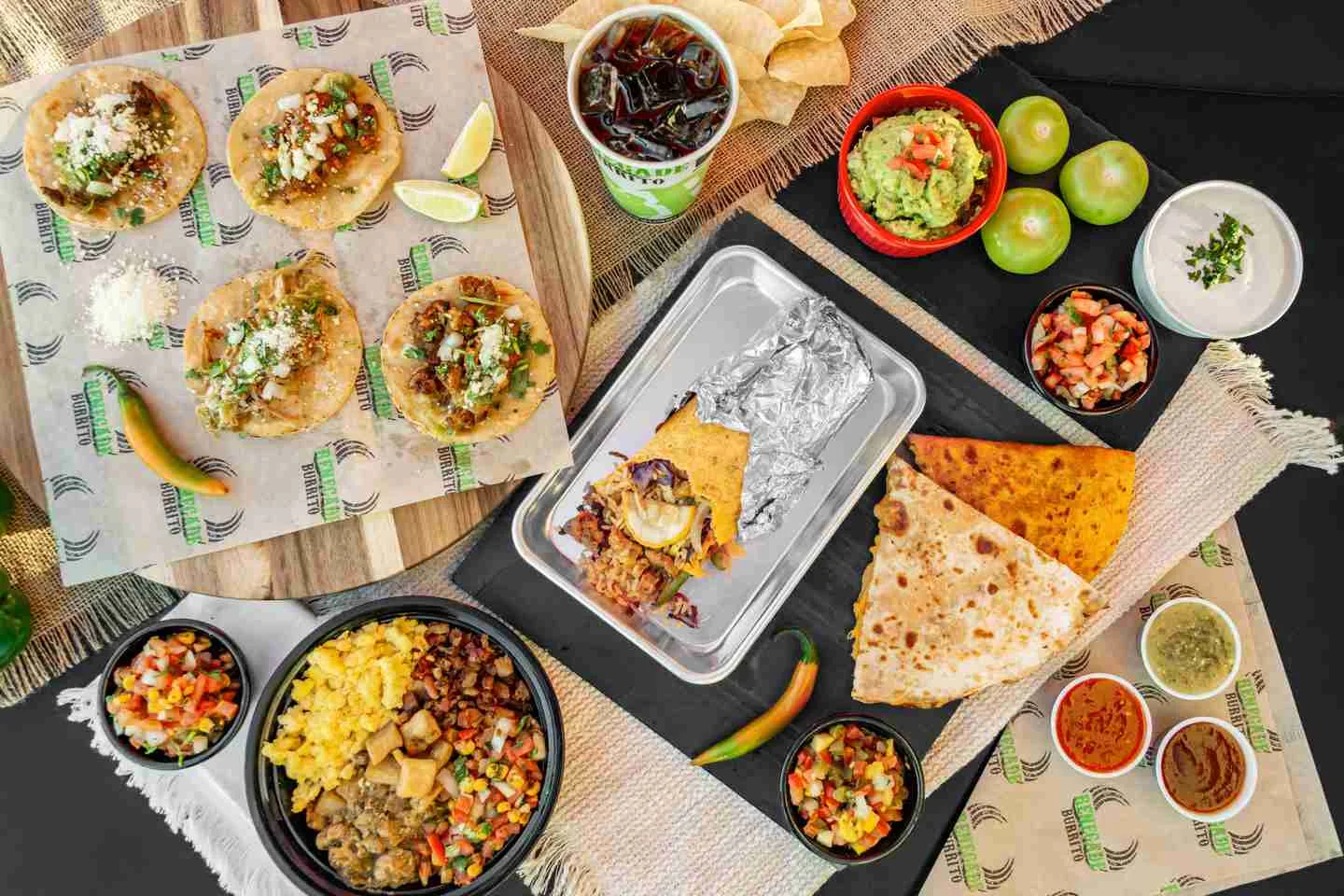 Delicious Mexican tacos with guacamole and sides