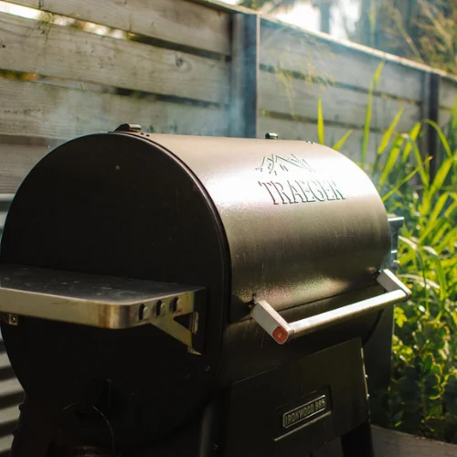 Traeger wood pellet grill in a sunny backyard setting
