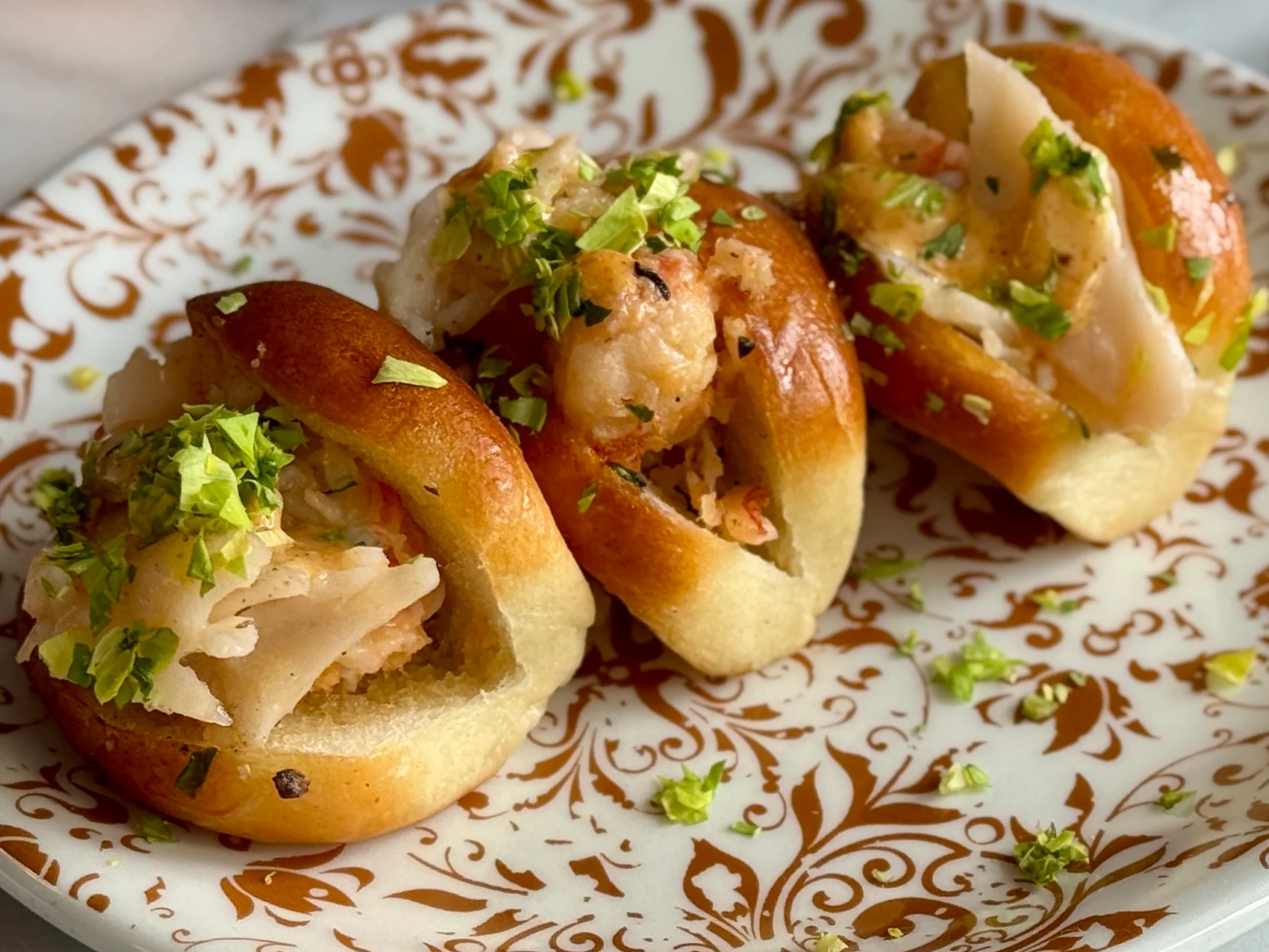 Shrimp pav bhaji sliders on a decorative plate